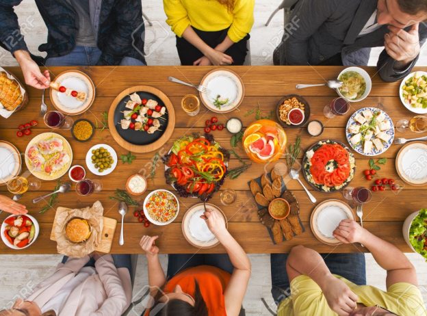 76860299 friends dinner table top view people eat healthy food together home party